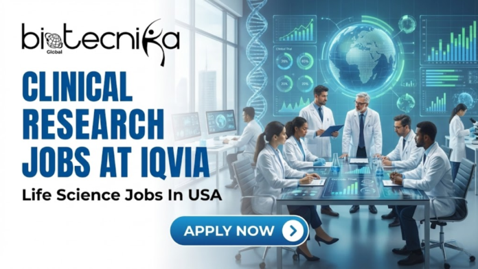 Team of clinical researchers and scientists working together in a high-tech laboratory with digital data screens, representing Clinical Research Jobs at IQVIA in the USA.