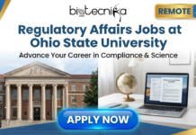 Remote Job Alerts in USA | Regulatory Affairs Jobs at Ohio State University Regulatory Affairs Jobs at Ohio State University. A featured image for a remote job posting, titled "Regulatory Affairs Jobs at Ohio State University" with the subtitle "Advance Your Career in Compliance & Science." It includes the Biotecnika Global logo and a "REMOTE JOB" tag. The background is split, showing the Ohio State University Thompson Library on the left and a home office setup with a laptop displaying a regulatory document on the right, with an "APPLY NOW" button at the bottom.