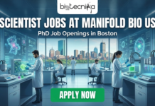 Scientist Jobs at Manifold Bio US | PhD Job Openings in Boston Scientist Jobs at Manifold Bio US | PhD Job Openings in Boston. A promotional banner with the "biotecnika Global" logo at the top. Large white text reads "SCIENTIST JOBS AT MANIFOLD BIO US," with "PhD Job Openings in Boston" below it. The background shows a futuristic laboratory with scientists working on advanced equipment, overlooking a city skyline of Boston. A green button with "APPLY NOW" is at the bottom.