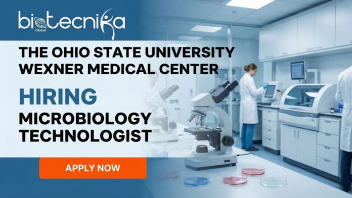 Microbiology Technologist working in a clinical microbiology laboratory with diagnostic testing equipment.