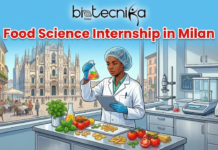 Food Science Internship in Milan | Cortilia Hiring Food Tech Graduates Food Science Internship in Milan. An illustration with a banner at the top that reads "biotecnika Global" and "Food Science Internship in Milan" in red and white text. The main image shows a Black woman in a white lab coat, hairnet, and gloves, holding a flask of colorful liquid and a tablet. She is standing in a food science laboratory with various equipment, including a microscope and scales. On the counter in front of her are fresh ingredients like tomatoes, basil, and pasta. Through a large window behind her, the Milan Cathedral (Duomo di Milano) and a bustling outdoor cafe are visible.
