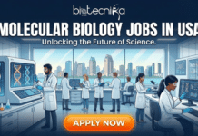 Molecular Biology Jobs in USA | Explore the Biological Researcher Role at Teva Pharmaceuticals Molecular Biology Jobs in USA | Researcher Role at Teva Pharma. A professional featured image for Biotecnika Global titled "MOLECULAR BIOLOGY JOBS IN USA" with the subtext "Unlocking the Future of Science." The illustration features a diverse team of molecular biologists in a state-of-the-art laboratory. One scientist is using a pipette near a high-tech DNA sequencing machine, while others analyze genetic data on advanced monitors. A large panoramic window in the background shows a modern US city skyline by the water. A glowing orange "APPLY NOW" button is centered at the bottom.