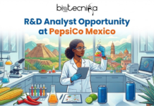 R&D Analyst Opportunity in Mexico | Research Jobs at PepsiCo You Can’t Miss in 2026 R&D Analyst Opportunity in Mexico Research Jobs at PepsiCo You Can't Miss in 2026. An illustration for a job opportunity featured by Biotecnika Global with the title text "R&D Analyst Opportunity at PepsiCo Mexico" at the top. The image depicts a female scientist in a modern laboratory, wearing a lab coat and safety glasses, holding a tablet and analyzing a flask of liquid. The lab bench is filled with scientific equipment, fresh ingredients like corn on the cob, chili peppers, limes, and an agave plant, alongside branded PepsiCo products including Pepsi cans and a bag of Lay's chips. The background window offers a view of an ancient Mayan pyramid and a Mexican cityscape.