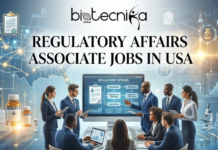 Regulatory Affairs Associate at AbbVie | Latest Life Science Jobs in USA Regulatory Affairs Associate at AbbVie | Life Science Jobs in USA. An office scene with diverse professionals in suits discussing regulatory pathways on a digital screen, with a map of the USA and life science icons in the background. The Biotecnika Global logo is at the top, and the text "REGULATORY AFFAIRS ASSOCIATE JOBS IN USA" is prominently displayed in the center.
