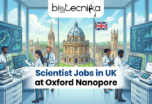 Scientist Jobs in UK at Oxford Nanopore | You Can’t Ignore in 2026 Scientist Jobs in UK at Oxford Nanopore You Can’t Ignore in 2026. An illustration for "Scientist Jobs in UK at Oxford Nanopore" with the Biotecnika Global logo at the top center. The image features a sophisticated laboratory setting in the UK, showcasing a scientist working with a compact, cutting-edge DNA sequencing device. Through a large window, the iconic architecture of Oxford is visible, blending historic academia with modern biotechnology. The scientist is looking at a high-resolution screen displaying real-time genomic data and nanopore sequencing strands. The overall theme is professional, innovative, and visually captivating.