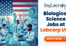 Latest Biological Science Jobs in the USA | Join Labcorp’s Microbiology Team Biological Science Jobs in the USA – Join Labcorp’s Microbiology Team. A promotional banner from Biotecnika Global advertising "Biological Science Jobs at Labcorp USA." The left half of the image features a stylized illustration of diverse scientists working in a modern laboratory with an American flag, the Statue of Liberty, and the Golden Gate Bridge in the background, along with DNA strands and molecular structures. The right half contains the text "Biological Science Jobs at Labcorp USA" in blue and orange, with an orange "APPLY NOW" button below it.