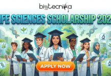 University of New Hampshire Department of Biological Sciences (DBS) Scholarships 2026–2027 | Apply Now Life Science Scholarship For Biology Student | Can’t Ignore in 2026. A promotional banner for the "LIFE SCIENCES SCHOLARSHIP 2026" from Biotecnika Global. The illustration shows a diverse group of seven smiling young students wearing white lab coats and graduation caps, holding tablets and scientific flasks. They are standing in front of a large globe surrounded by scientific icons like DNA strands, plants, and microscopes, with green campus buildings in the background. An orange "APPLY NOW" button is centered at the bottom.