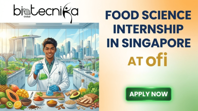 Food Science Internship in Singapore at ofi Don’t Miss This Opportunity. A promotional graphic with the Biotecnika Global logo in the top left. The left side features a cartoon illustration of a smiling young man in a lab coat and gloves, holding a bubbling flask in a food science laboratory filled with fresh fruits, vegetables, and ingredients, with the Singapore skyline visible through a window. The right side contains large text that reads
