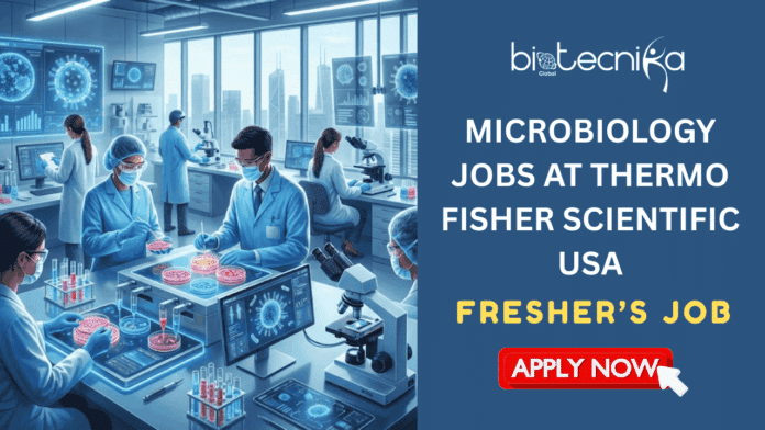 High-Demand Fresher's Microbiology Jobs in USA Thermo Fisher Scientific Hiring Now. A professional job recruitment banner for Biotecnika Global. The left side features a high-tech microbiology laboratory where scientists in blue scrubs and protective gear work with glowing petri dishes, microscopes, and digital monitors showing viral structures. The right side has a dark blue background with the Biotecnika Global logo at the top, bold white text reading