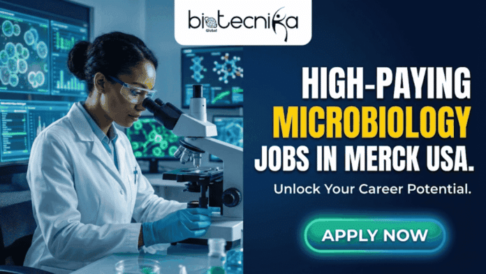 High Paying Microbiology Jobs at Merck USA Applications Invited! An advertisement banner featuring the Biotecnika Global logo in the top left. On the left side, a Black woman scientist in a white lab coat, gloves, and safety glasses is looking into a microscope in a modern laboratory with digital screens displaying scientific data. On the right side, large white and yellow text reads