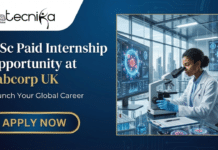MSc Internship Opportunity in the UK | Global Paid Internship Program at Labcorp MSc Internship Opportunity in the UK Global Paid Internship Program at Labcorp. A professional job advertisement banner for an MSc Paid Internship at Labcorp UK. The left side features bold, elegant typography on a deep blue background with a prominent gold "Apply Now" button. The top-left corner displays the Biotecnika Global logo. The right side showcases a high-tech laboratory setting where a scientist is working with a microscope and advanced digital data displays, reflecting a sophisticated and premium global career opportunity.