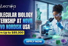 Earn Upto $89,000 With Molecular Biology Internship at Novo Nordisk USA | Apply Now Molecular Biology Internship at Novo Nordisk USA Earn $89,000. Gemini said A featured image for a job advertisement titled "MOLECULAR BIOLOGY INTERNSHIP AT NOVO NORDISK USA" in bold white and light blue text, with a highlighted banner stating "Earn Up to $89,000." The illustration depicts a female scientist in a white lab coat and safety glasses working meticulously with a microscope and pipette in a high-tech laboratory. Glowing holographic DNA helices and molecular structures float around her workspace. Through the large window in the background, the Statue of Liberty is visible, signifying the US location. The Biotecnika Global logo is placed at the top left, and a bright blue "Apply Now" button is at the bottom center.