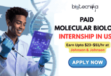 Paid Molecular Biology Internship in USA | Earn Upto $23–$51/hr at Johnson & Johnson Paid Molecular Biology Internship in USA Earn Upto $23–$51hr at Johnson & Johnson. A promotional image for a "Paid Molecular Biology Internship in USA" by Biotecnika Global. On the left, a young male scientist in a lab coat and gloves smiles while holding a pipette and a UV-lit gel electrophoresis plate. Behind him is a large DNA helix and a map of the United States. On the right, large blue and gold text reads "Paid Molecular Biology Internship in USA", followed by "Launch Your Science Career – Apply Today!". Below it is a blue and yellow "APPLY NOW" button. The Biotecnika Global logo is at the top center.