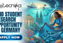 PhD Student Research Opportunity in Germany | GEOMAR Hiring Now PhD Student Research Opportunity in Germany GEOMAR Hiring Now. A featured image for a job posting titled "PHD STUDENT RESEARCH OPPORTUNITY IN GERMANY." The illustration features a marine biology theme, showing a female researcher inside a high-tech submersible operating a robotic arm to study vibrant coral reefs. The underwater scene uniquely blends science and culture by featuring submerged German landmarks, like the Brandenburg Gate and Cologne Cathedral, surrounded by manta rays and tropical fish. On the water's surface, a research vessel with a German flag is visible against a sunset sky. The Biotecnika Global logo is at the top left, and a glowing blue "Apply Now" button is at the bottom left.