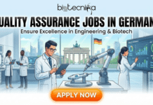 Quality Assurance Jobs in Germany | Bio-Rad Laboratories Hiring Now Quality Assurance Jobs in Germany Bio-Rad Laboratories Hiring Now. A professional recruitment banner for Biotecnika Global titled "QUALITY ASSURANCE JOBS IN GERMANY" in bold black text. The tagline reads "Ensure Excellence in Engineering & Biotech." The illustration shows a diverse team of scientists and engineers in a modern, high-tech quality control lab. A specialist uses a tablet to control a robotic precision arm testing a component, while another monitors a large digital screen displaying "PASS" for a quality check. The background through the windows features the Brandenburg Gate and the German flag. A large orange "APPLY NOW" button is at the bottom.