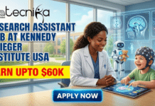 Research Assistant Job in USA | Work at Kennedy Krieger Institute & Earn Upto $60K Research Assistant Job in USA Work at Kennedy Krieger Institute & Earn Upto $60K. A featured image for a job advertisement from Biotecnika Global. The headline text reads, "RESEARCH ASSISTANT JOB AT KENNEDY KRIEGER INSTITUTE USA." Below it, a yellow banner highlights, "EARN UPTO $60K." A blue button at the bottom says, "APPLY NOW." The illustration shows a smiling female researcher in a lab coat observing a happy young child wearing an EEG cap, who is pointing at a tablet displaying brain activity mapping. In the background, there is a small robot holding a teddy bear and holographic displays of brain scans and neurons in a modern clinic setting.