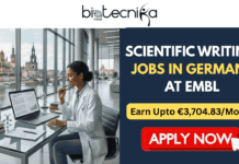 Scientific Writing Jobs in Germany at EMBL | Earn Upto €3,704.83/Month Scientific Writing Jobs in Germany at EMBL Earn Upto €3,704.83Month. A job advertisement banner from Biotecnika Global. On the left, a Black woman in a lab coat works on a laptop at a desk with scientific models, overlooking a European cityscape with a river. On the right, against a blue and gold circuit board background, large white text reads "SCIENTIFIC WRITING JOBS IN GERMANY AT EMBL" with the tagline "Craft the Narrative of Discovery. Join a World-Class Institute." Below it is an orange "APPLY NOW" button.