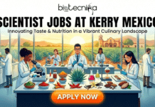 BSc Food Science Apply Online For Scientist Jobs at Kerry, Mexico Scientist Jobs at Kerry Mexico. A professional recruitment banner for Biotecnika Global titled "SCIENTIST JOBS AT KERRY MEXICO" in bold black text, with the tagline "Innovating Taste & Nutrition in a Vibrant Culinary Landscape." The illustration shows a diverse team of scientists in a modern food science laboratory. On the central lab bench, there are various ingredients including chili peppers, cocoa beans, vanilla pods, and colorful spice powders. Large windows in the background reveal an agave field and a traditional Mexican hacienda under a rising sun. A prominent orange "APPLY NOW" button is at the bottom.