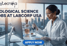 Biological Science Jobs at Labcorp USA | Apply For Technologist Trainee Microbiology Today! Biological Science Jobs at Labcorp USA Technologist Trainee Featured image for a job advertisement from biotecnika Global. The text reads: "BIOLOGICAL SCIENCE JOBS AT LABCORP USA". A focused woman in a white lab coat and safety glasses sits at a desk in a modern high-tech laboratory, using a pipette on a multi-well plate. Behind her, a large window reveals a coastal city skyline at twilight. Below her, a blue button with white text says "APPLY NOW".
