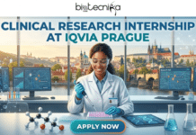 Clinical Research Internship in Europe at IQVIA for Life Science Graduates | Don’t Miss Out Clinical Research Internship in Prague for Life Science Graduates Don’t Miss Out. An infographic promotional banner for a 'CLINICAL RESEARCH INTERNSHIP AT IQVIA PRAGUE.' The upper part features the text, including the brand logo 'biotecnika' at the very top. Below this, the main title text 'CLINICAL RESEARCH INTERNSHIP AT IQVIA PRAGUE' is prominent. The central visual shows a female scientist, wearing safety glasses and a lab coat, working at a lab bench. She is focused on pipetting a solution from a pipette into a microplate. In the background, there is a large window offering a stunning, wide view of the historic Prague skyline, including Charles Bridge and Prague Castle. On the lab bench and around her are molecular models, beakers, and multiple computer monitors. One monitor shows a DNA helix, others show a stylized map of Prague with location pins labeled 'Research Hub,' and another on the far right shows a Gantt chart labeled 'Trial Data.' A tablet on the desk also shows a DNA helix. The overall theme is a blend of research, data, location, and opportunity. At the very bottom center is a prominent teal 'APPLY NOW' button.