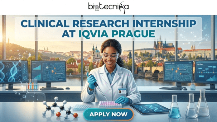 Clinical Research Internship in Prague for Life Science Graduates Don’t Miss Out. An infographic promotional banner for a 'CLINICAL RESEARCH INTERNSHIP AT IQVIA PRAGUE.' The upper part features the text, including the brand logo 'biotecnika' at the very top. Below this, the main title text 'CLINICAL RESEARCH INTERNSHIP AT IQVIA PRAGUE' is prominent. The central visual shows a female scientist, wearing safety glasses and a lab coat, working at a lab bench. She is focused on pipetting a solution from a pipette into a microplate. In the background, there is a large window offering a stunning, wide view of the historic Prague skyline, including Charles Bridge and Prague Castle. On the lab bench and around her are molecular models, beakers, and multiple computer monitors. One monitor shows a DNA helix, others show a stylized map of Prague with location pins labeled 'Research Hub,' and another on the far right shows a Gantt chart labeled 'Trial Data.' A tablet on the desk also shows a DNA helix. The overall theme is a blend of research, data, location, and opportunity. At the very bottom center is a prominent teal 'APPLY NOW' button.