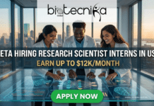 Dream Internship Alert: Meta Hiring Research Scientist Interns in USA | Earn Up to $12K/Month Dream Internship Alert Meta Hiring Research Scientist Interns in USA Earn Up to $12KMonth. An advertisement from biotecnika Global with the main headline: 'META HIRING RESEARCH SCIENTIST INTERNS IN USA' and the tagline: 'EARN UP TO $12K/MONTH'. The visual scene shows three diverse, smiling researchers—an Indian woman, a Black man, and a Latina woman—in white lab coats collaborating at a large, futuristic, transparent touchscreen table. The table displays intricate, glowing blue schematics of neural networks, genetic sequences, AI model optimization data, and a brain with 'NEURAL NETWORK MAPPING' text. The setting is a modern, glass-walled high-rise office with a stunning golden hour sunset over an American city skyline in the background. At the bottom center, a prominent green button reads: 'APPLY NOW'.