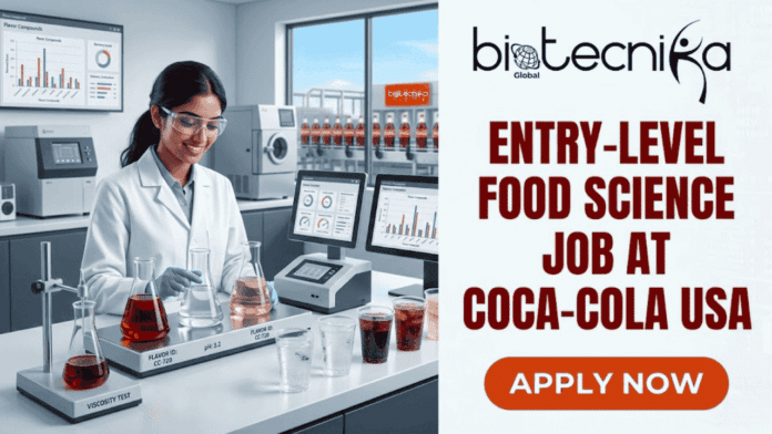 Entry-Level Food Science Job at Coca-Cola USA Earn Upto $27. A horizontally-split featured image. On the left, a smiling young female scientist in safety glasses and a lab coat pours red liquid in a detailed, modern food science laboratory with analytical equipment, screens displaying charts related to flavor and sensory scores, various beakers with colored liquids, two cups with dark carbonated drink and ice, and prominent Coca-Cola branding including bottles in the background. The counter includes text such as 'VISCOSITY TEST' and on a flask base 'FLAVOR ID: CC-720, PH: 3.2'. The right side features the black and white 'biotecnika Global' logo at the top, followed by large reddish-brown capitalized text: 'ENTRY-LEVEL FOOD SCIENCE JOB AT COCA-COLA USA'. A large orange button at the bottom right has bold white capitalized text: 'APPLY NOW'.