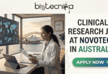 Clinical Research Job at Novotech Australia | Life Sciences Candidates are Eligible Clinical Research Job at Novotech Australia | Life Sciences Careers. Job banner for a Clinical Research position at Novotech in Australia. The Biotecnika Global logo is at the top. The left features a modern office scene with a researcher working and a clear view of the Sydney Opera House through the window. Prominent text on the right states: 'CLINICAL RESEARCH JOB AT NOVOTECH IN AUSTRALIA'. Below the text is a green-to-blue gradient button reading 'APPLY NOW' with an arrow.