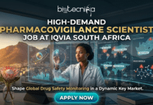 High-Demand Scientist Job in South Africa – Become a Pharmacovigilance Expert with IQVIA! High-Demand Scientist Job in South Africa – Become a Pharmacovigilance Expert with IQVIA!. A promotional banner for a high-demand pharmacovigilance scientist job at IQVIA South Africa. An African woman scientist in a biotechnika lab coat is using gesture controls on a transparent digital display that shows global adverse event maps and drug data analytics. Above her, text reads "HIGH-DEMAND PHARMACOVIGILANCE SCIENTIST JOB AT IQVIA SOUTH AFRICA" under the "biotechnika Global" logo. The background features a sunset view of Table Mountain and Cape Town. In the foreground are a Protea flower and a tablet. A large "APPLY NOW" button is at the bottom center.