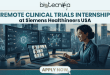 Remote Clinical Trials Internship at Siemens Healthineers | Work from Home and Get $40/hr Remote Clinical Trials Internship at Siemens Healthineers Work from Home and Get $40hr. A featured image for a job page, starting at the top with the Biotecnika Global logo and the large, bold title, "REMOTE CLINICAL TRIALS INTERNSHIP at Siemens Healthineers USA." The central image is of a smiling professional Black woman in a blue shirt, seated at a desk and holding a tablet and stylus. Her sophisticated multi-monitor setup includes a large curved monitor displaying detailed 3D molecular structures and trial data with DNA icons, a second monitor with intricate networked data visualization and graphs for a 'Clinical Trial,' and a laptop displaying a grid of six diverse people in a video conference meeting. Through a large window behind her, a modern city skyline is visible at dusk, with a small American flag on a distant desk. At the bottom center, a gold-colored button with a mouse pointer hovering over it reads "APPLY NOW".