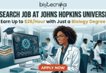 Research Job at Johns Hopkins University | Earn Up to $26/Hour with Just a Biology Degree Research Job at Johns Hopkins University Earn Up to $26Hour with Just a Biology Degree. A modern digital illustration of a featured image for a job page. At the top, a light blue banner contains the centered text header in black and gold: "RESEARCH JOB AT JOHNS HOPKINS UNIVERSITY", with the "biotecnika Global" logo directly above it. Below, the tagline reads: "Earn Up to $26/Hour with Just a Biology Degree", where "$26/Hour" and "Biology Degree" are highlighted in a rich gold color. Floating dollar bills are in the top corners. To the left of the text, a small stack of 'BIOLOGY' books with a graduation cap on top floats. The central focus is a smiling Black woman with glasses and a lab coat, seated at a modern lab desk and wearing blue gloves. She is actively using a multichannel pipette to sample from a petri dish into tubes, looking towards the viewer. In the foreground, a large computer monitor displays an intricate digital interface with a glowing green virus-like structure, a rotating DNA double helix, and data charts. Other diverse researchers are working with microscopes and computer stations further back in the clean laboratory. A prominent, rounded orange button at the bottom center-left contains the bold, white text: "APPLY NOW". The entire composition is a detailed illustration with a depth of field that keeps the central figure sharp.
