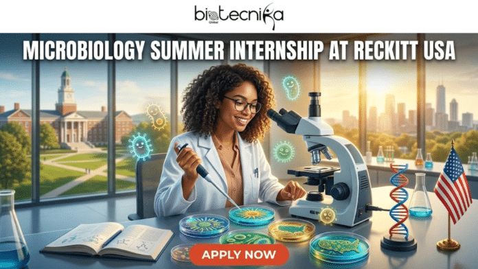 Microbiology Summer Internship at Reckitt USA Apply Before It's Gone. A promotional banner for a microbiology summer internship at Reckitt USA, featuring the Biotecnika Global logo at the top. The central image shows a smiling Black woman in a lab coat and glasses, looking into a microscope at a laboratory bench. She uses a micropipette to work on petri dishes, some containing bacterial cultures forming the shape of the USA map, with glowing cartoon microbes floating around. The lab bench also holds an open textbook, a DNA model, beakers, and an American flag. Background windows look out onto a university campus on the left and a modern city skyline on the right. An orange 'APPLY NOW' button is at the bottom center.